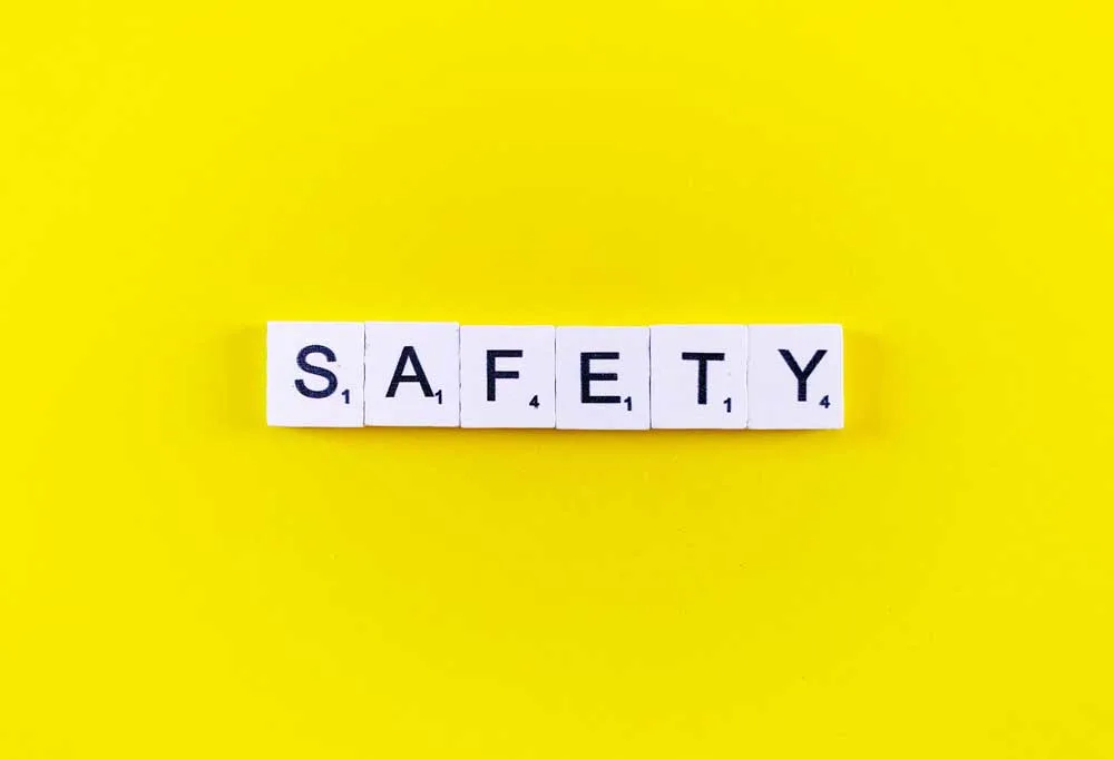 Yellow background with lettered tiles spelling out "Safety"