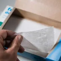 Dryer sheets being pulled from its packaging
