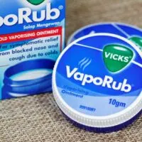 Canister of Vicks Vapo Rub resting on a piece of burlap