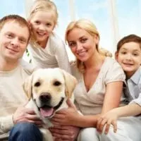 Portrait of a family with their yellow lab