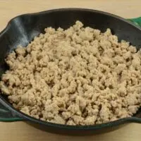 Cooked ground turkey in a cast iron skillet