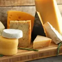Variety of cheeses on a cutting board