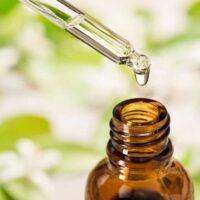 Eye dropper over the top of a bottle of essential oil